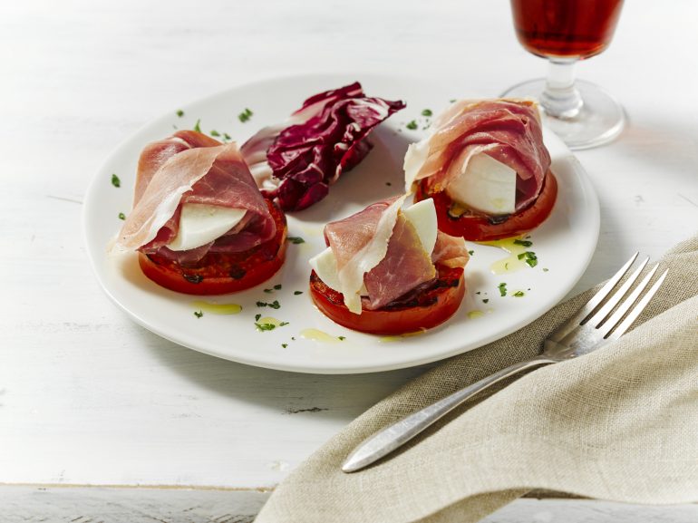 Slices of tomato topped with mozzarella, Prosciutto and a balsamic drizzle, served with a glass of Fino Sherry