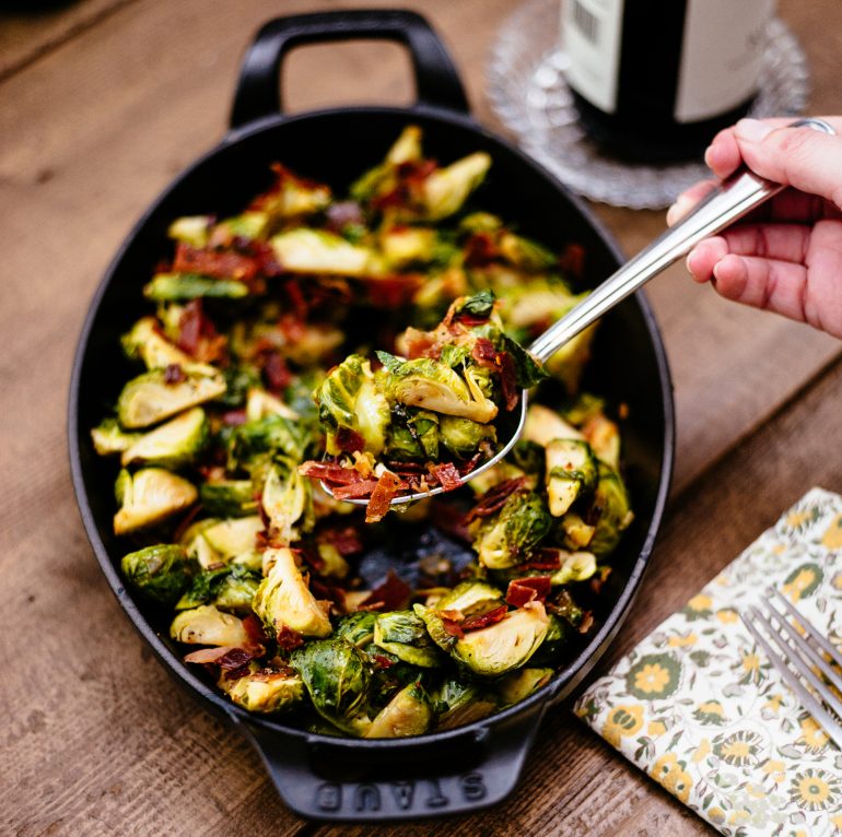 Sautéed brussels sprouts with prosciutto in a cast iron dish